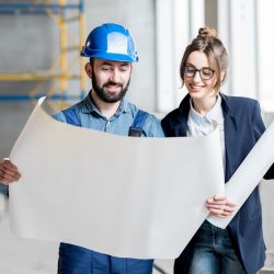 Builder with businesswoman at the construction site